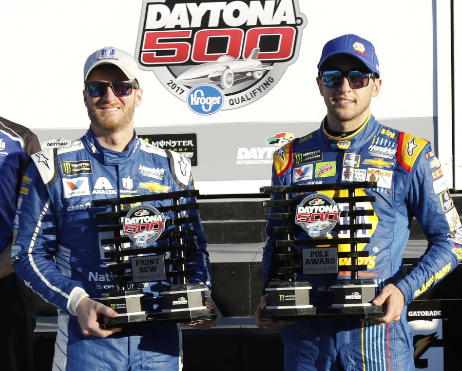 Dale Earnhardt Jr., left, and Chase Elliott display their front row trophies after qualifying for the top two positions in the NASCAR Daytona 500 auto race at Daytona International Speedway, Sunday, Feb. 19, 2017, in Daytona Beach, Fla.