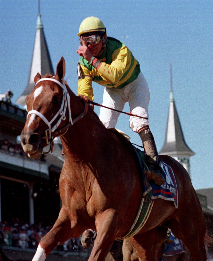 Jockey Chris Antley gestures aboard Charismatic after crossing the finish line to capture the 125th running of the Kentucky Derby in Louisville, Ky., on May 1, 1999. Former Kentucky Derby and Preakness Stakes winner Charismatic has died at a thoroughbred retirement farm in Kentucky. Old Friends farm says the chestnut horse that won the first two legs of the Triple Crown in 1999 was found dead in his stall Sunday, Feb. 19, 2017.