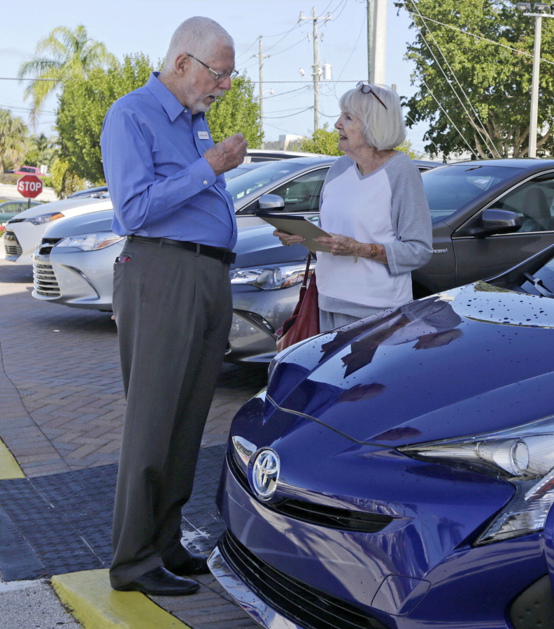 Earl Stewart, owner of a Toyota dealership, talks to a customer at his business Feb. 10 in North Palm Beach, Fla. Stewart advises people to ignore dealer advertising. &quot;Probably 99 percent of it is misleading,&quot; he said.