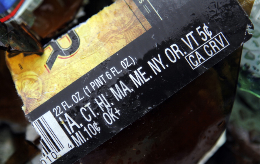 Redemption amounts for separate states is shown on a broken bottle label at a collection site in Beaverton, Ore.