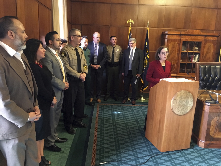 Oregon Gov. Kate Brown speaks Thursday during a press conference in the Capitol ceremonial office in Salem, Ore. Brown signed an executive order broadening Oregon&#039;s commitment to its status as a sanctuary state.