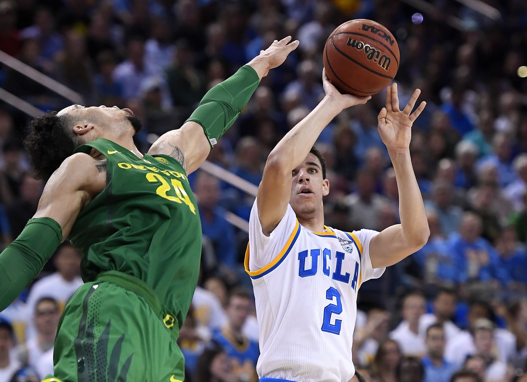 UCLA guard Lonzo Ball, right, shoots as Oregon forward Dillon Brooks defends during the second half of an NCAA college basketball game, Thursday, Feb. 9, 2017, in Los Angeles. UCLA won 82-79. (AP Photo/Mark J.