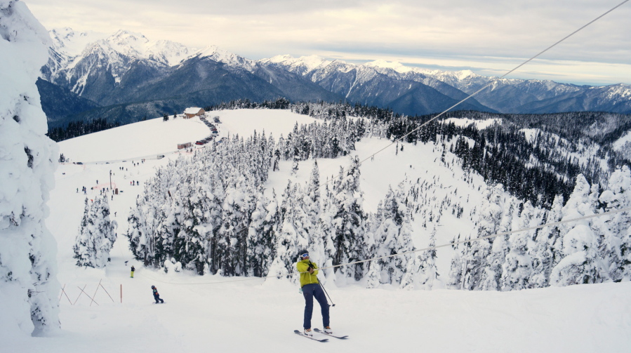 This photo taken Jan. 7, 2017, shows a skier nears the top of the rope tow at Hurricane Ridge in Olympic National Park, Wash. The visitor center is in the background.