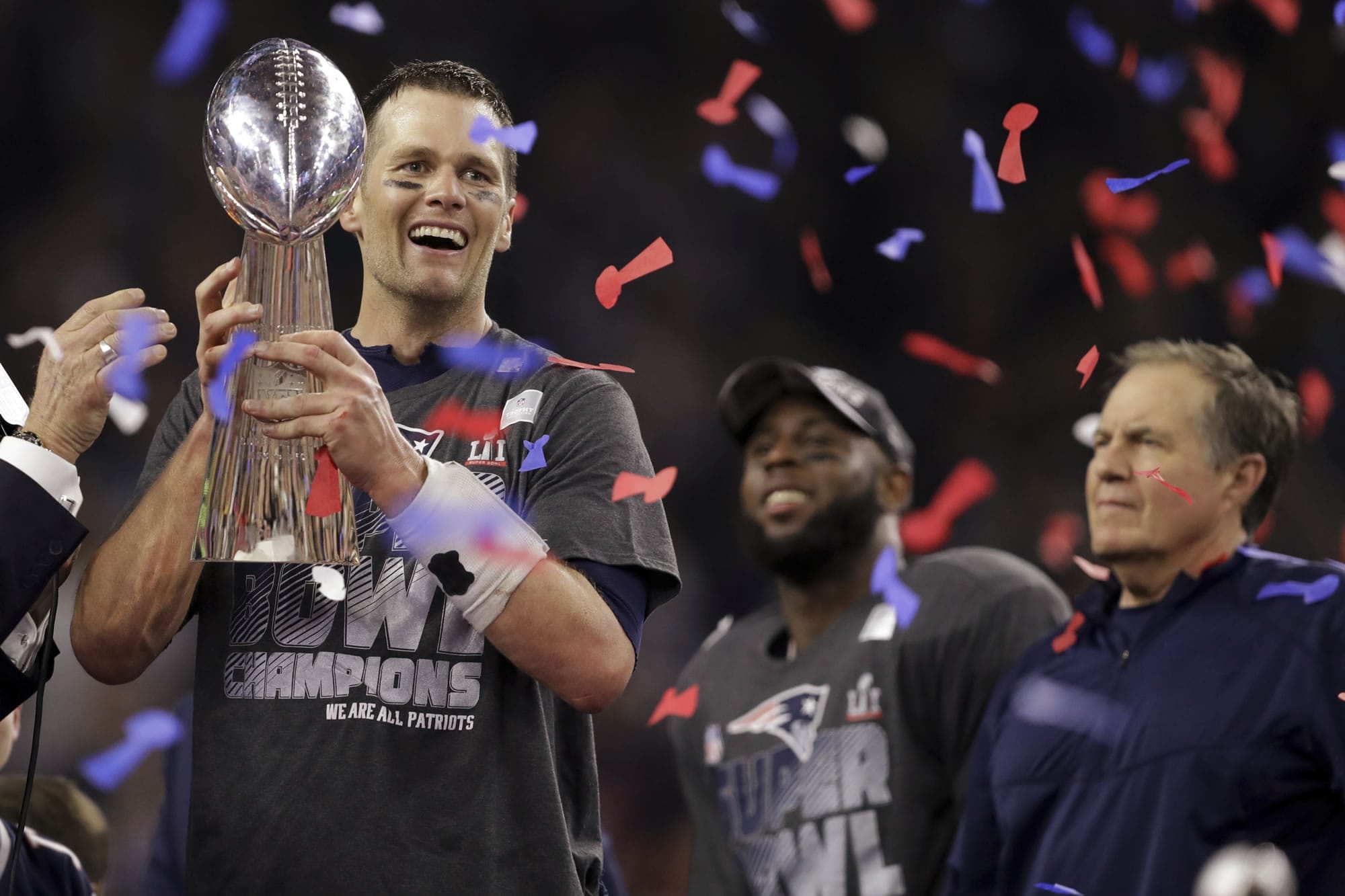 New England Patriots' Tom Brady holds the Vince Lombardi Trophy after defeating the Atlanta Falcons in overtime at the NFL Super Bowl 51 football game Sunday, Feb. 5, 2017, in Houston. The Patriots defeated the Falcons 34-28. At right is Patriots head coach Bill Belichick.