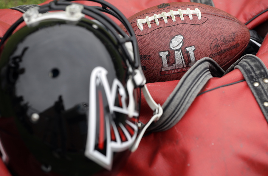 A Super Bowl 51 football and Atlanta Falcons helmet sit on the sideline as the Atlanta Falcons practice for the NFL Super Bowl 51 football game Feb. 3 in Houston.