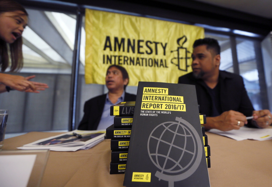 A reporter, left, talks to Amnesty International, Philippines&#039; Jose Noel Olano and Wilnor Papa, right, following the release of the 2016-17 Amnesty International report which they released at a news conference Wednesday in suburban Quezon city northeast of Manila, Philippines. Amnesty International says &quot;toxic&quot; fear-mongering by anti-establishment politicians, among them President Donald Trump and the leaders of Turkey, Hungary and the Philippines, is contributing to a global pushback against human rights.