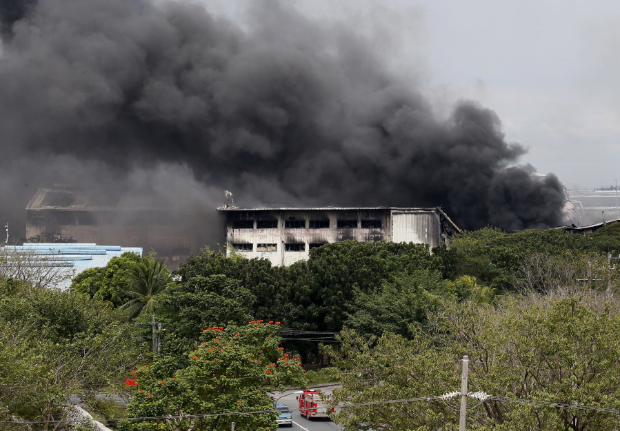 Fire continues to burn at the House Technology Industries factory Thursday in General Trias township, south of Manila, Philippines.