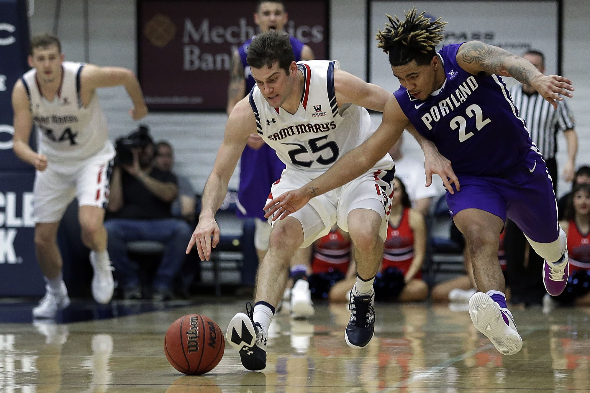 Portland's Jazz Johnson, right, and Saint Mary's Joe Rahon (25) chase a loose ball during the second half of an NCAA college basketball game Thursday, Feb. 9, 2017, in Moraga, Calif.