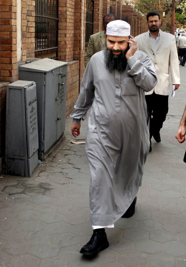 Egyptian cleric Osama Hassan Mustafa Nasr, known as Abu Omar, talks on his mobile April 11, 2007 as he walks at a Cairo street after attending Amnesty International press conference in Cairo, Egypt.