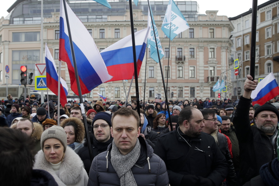 Russian opposition leader Alexei Navalny, center, and his wife Yulia, left, take part Sunday in a march in memory of opposition leader Boris Nemtsov in Moscow. Two years ago, Nemtsov was gunned down outside the Kremlin.