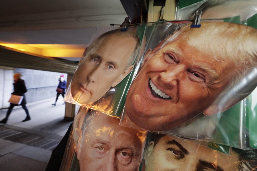 Face masks depicting Russian President Vladimir Putin and U.S. President Donald Trump hang for sale at a souvenir street shop in St. Petersburg, Russia.