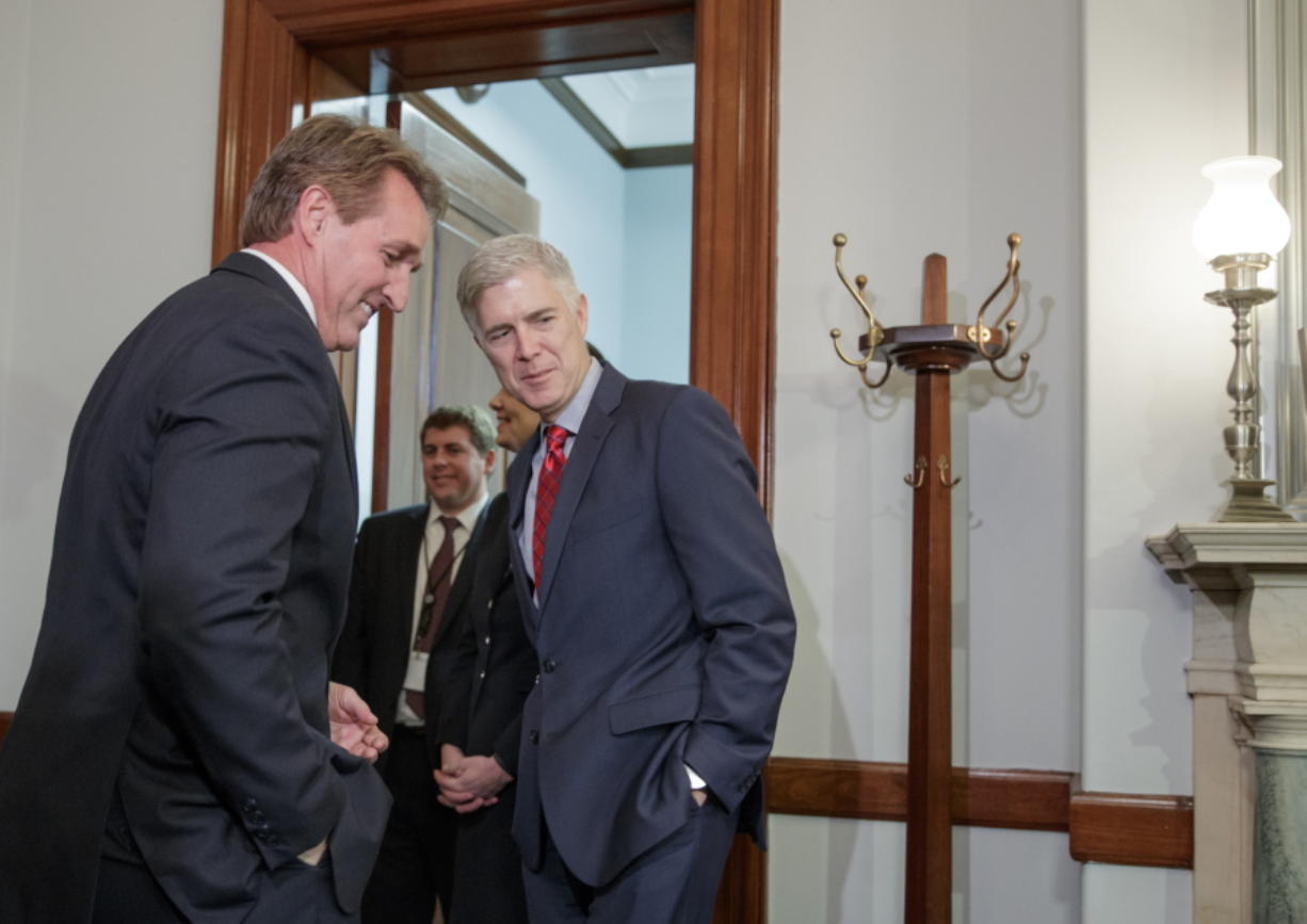 Supreme Court Justice nominee Neil Gorsuch meets with Senate Judiciary Committee member Sen. Jeff Flake, R-Ariz., on Wednesday on Capitol Hill in Washington. (AP Photo/J.
