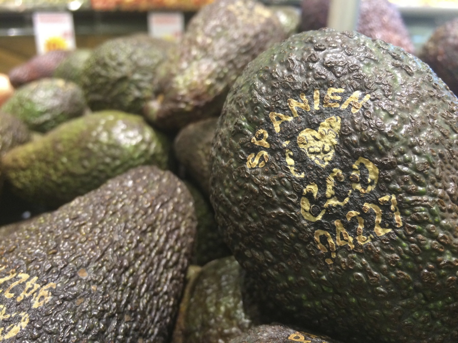Laser-branded avocados are displayed Jan. 31 at the ICA Kvantum supermarket in Malmo, Sweden. The marks remove some pigment from the outer skin and replace the use of plastic stickers. They also reduce the need for plastic packaging of many kinds of produce.
