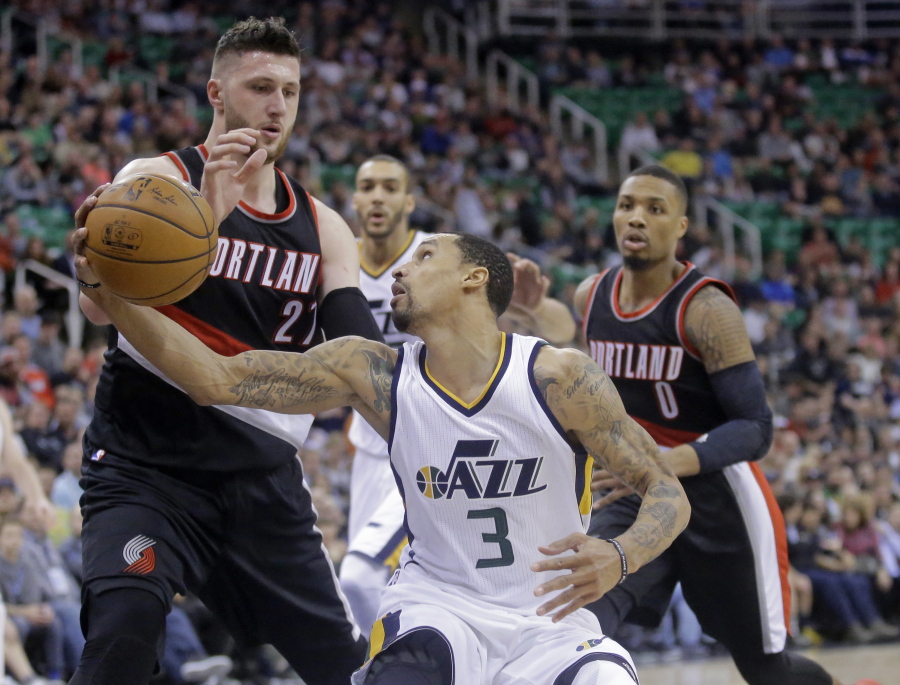 Utah Jazz guard George Hill (3) looks at the basket as Portland Trail Blazers center Jusuf Nurkic, left, defends during the second half of an NBA basketball game Wednesday, Feb. 15, 2017, in Salt Lake City. The Jazz won 111-88.