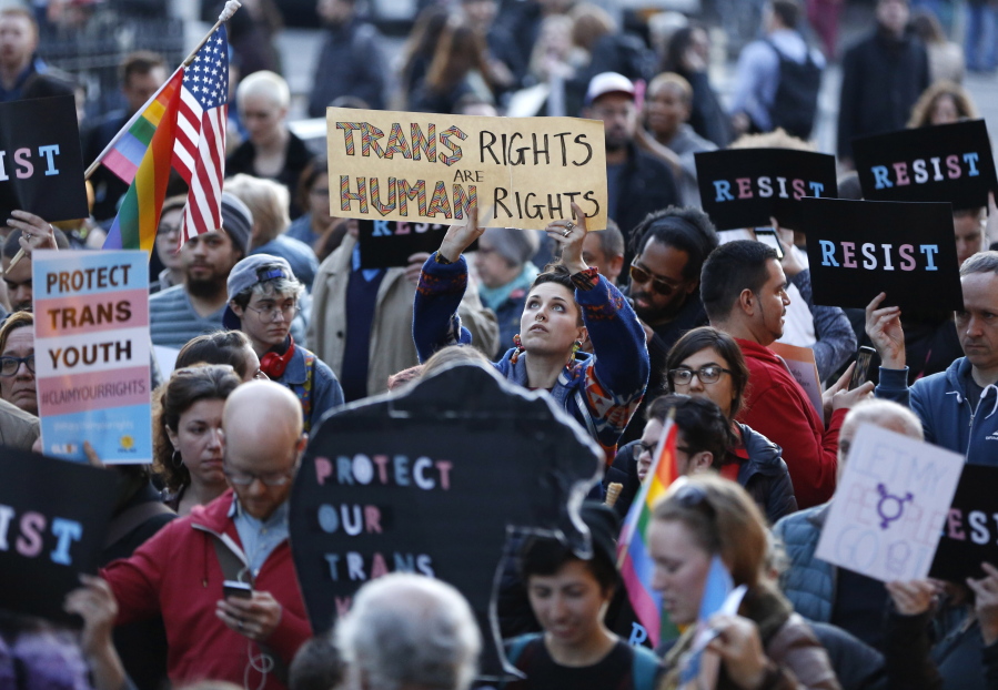 An attendee holds a sign during a rally Thursday supporting transgender youth at the Stonewall National Monument in New York. The crowd gathered to speak out against the decision to roll back a federal rule saying public schools had to allow transgender students to use the bathrooms and locker rooms of their chosen gender identity.