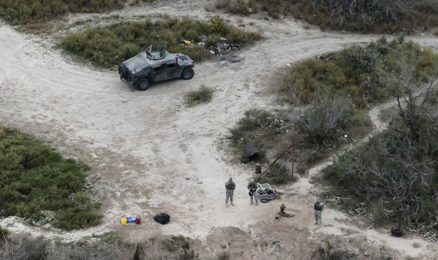 Members of the National Guard patrol Feb. 24, 2015, along the Rio Grande at the Texas-Mexico border in Rio Grande City, Texas. The Trump administration is considering a proposal to mobilize as many as 100,000 National Guard troops to round up unauthorized immigrants, including millions living nowhere near the Mexico border, according to a draft memo obtained by The Associated Press.
