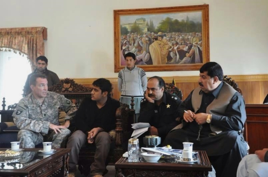 In this 2010 photo provided by U.S. Army Capt. Matthew Ball shows his interpreter Qismat Amin, second seated from left, in Jalalabad, the capital of Nangarhar province of Afghanistan. Amin, who has been living in hiding after getting threats from Taliban and Islamic state fighters, got his visa Sunday after nearly four years of interviews. Ball bought him a $1,000 plane ticket to San Francisco and plans to meet him at the airport with an attorney. Ball said he has bought a plane ticket for his Afghan translator in case that country is added to the list of banned nations. ( U.S. Army Capt.