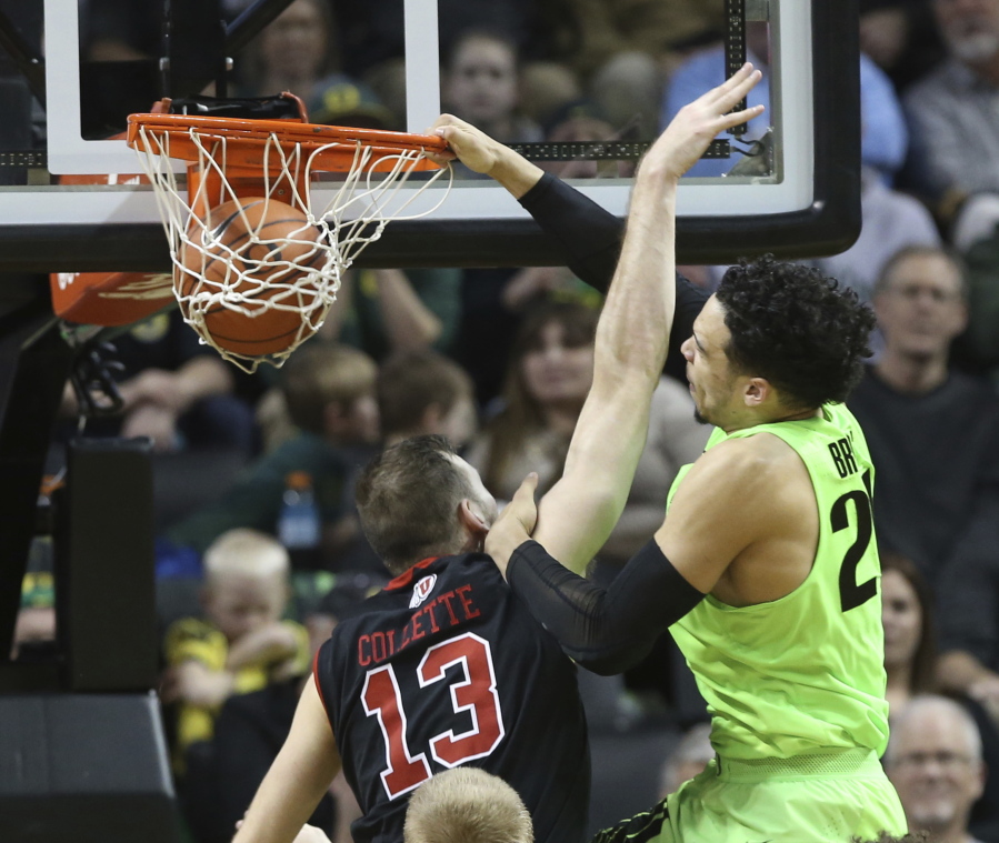 Oregon&#039;s Dillon Brooks, right, dunks over Utah&#039;s David Collette during the second half of an NCAA college basketball game Thursday, Feb. 16, 2017, in Eugene, Ore.