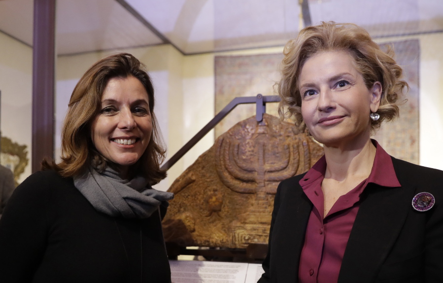 Barbara Jatta, left, director of the Vatican Museums, and Alessandra Di Castro, director of Rome&#039;s Jewish Museum, stand in front of a bas relief showing a menorah at the end of a Monday press conference in Rome.