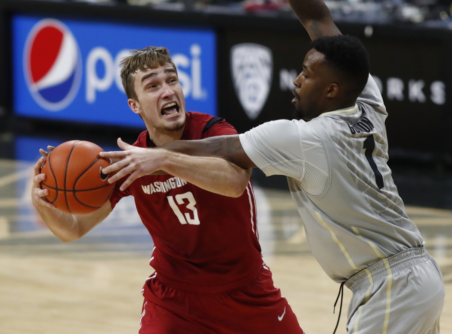 Washington State forward Jeff Pollard, left, drives the lane to the net as Colorado forward Wesley Gordon defends in the first half of an NCAA college basketball game, Sunday, Feb. 12, 2017, in Boulder, Colo.