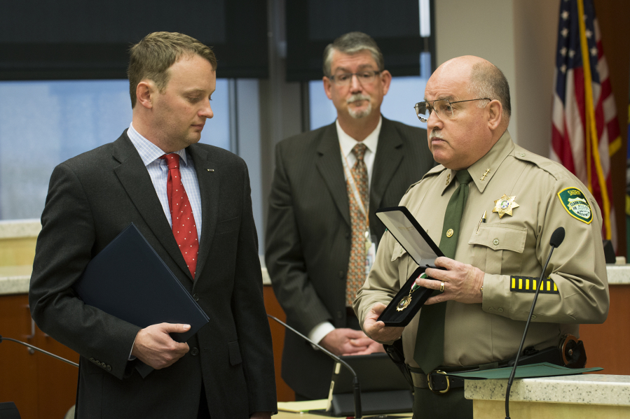 Neil Burkhardt receives a Citizen Service medal from Garry Lucas, then Clark County sheriff, in 2014 for intervening in an office shooting. Burkhardt is among 177 Carnegie Heroes listed in the foundation&#039;s 2015-2016 report, released last week.