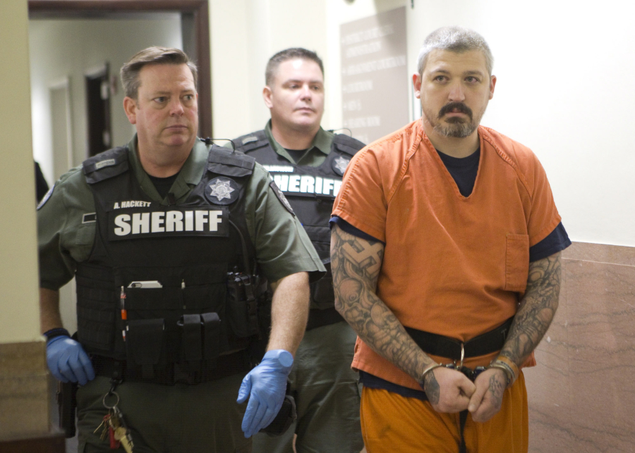 Brent Luyster, the man accused in a Woodland triple homicide and attempted jail escape, is escorted by Clark County corrections deputies to a Nov. 8 court appearance. Prosecutors on Thursday announced they will not seek the death penalty against Luyster who is charged with aggravated murder.