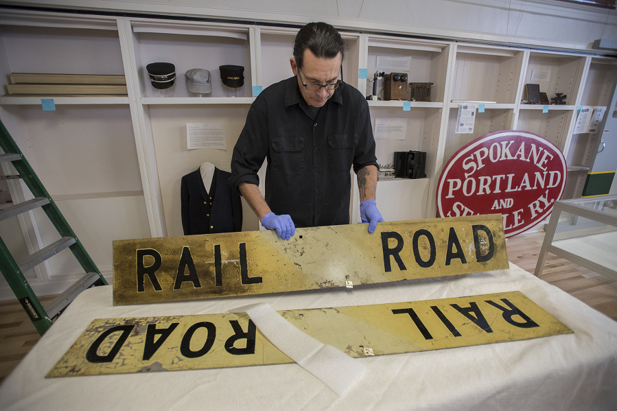 Todd Clark helps assemble a sign for the exhibit that opened Saturday at the Clark County Historical Museum.