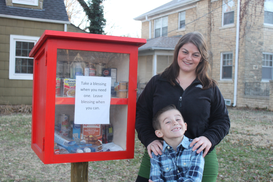 Maggie Ballard and her son Paxton Burns, 6, stand in front of the &quot;Blessing Box&quot; in front of their Wichita, Kan., home. Anyone can come and take food or toiletries as needed, or leave a blessing for someone else.