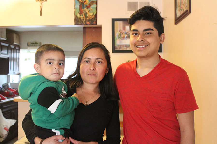 Margarita Ruiz, 33, stands with two of her sons, Alex, 2, and Miguel, 14. Ruiz says she relies on office staff to interpret during visits to her children&#039;s doctor. She doesn&#039;t speak English and her kids&#039; pediatrician speaks very little Spanish. (Ana B.