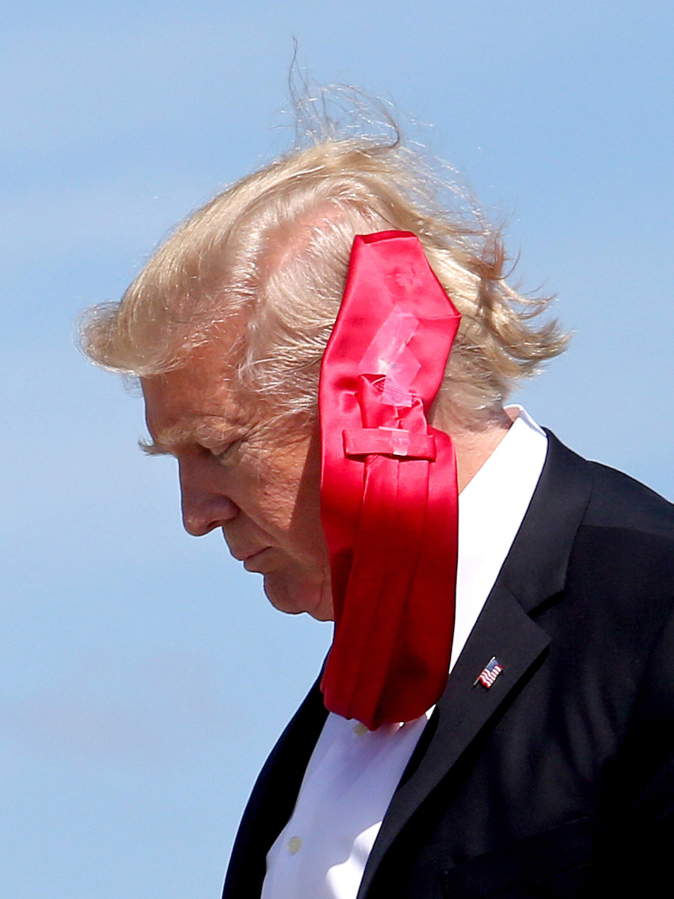 A strong wind blows President Donald Trump&#039;s tie March 3 as he arrives at Orlando International Airport for a visit to St. Andrew Catholic School.