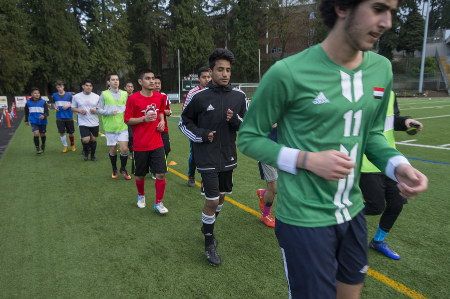 Members of the Fort Vancouver boys soccer team, which includes players who hail from 16 different nations, jog together during practice at Kiggins Bowl on Tuesday.