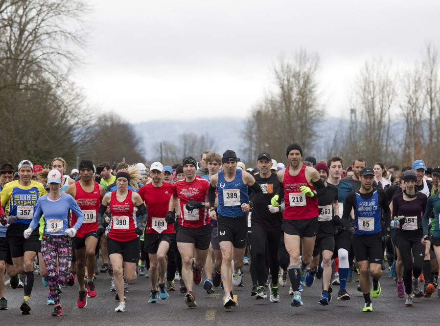Racers take off from the starting line Feb. 26 as they take part in the Vancouver Lake half-marathon in Vancouver.