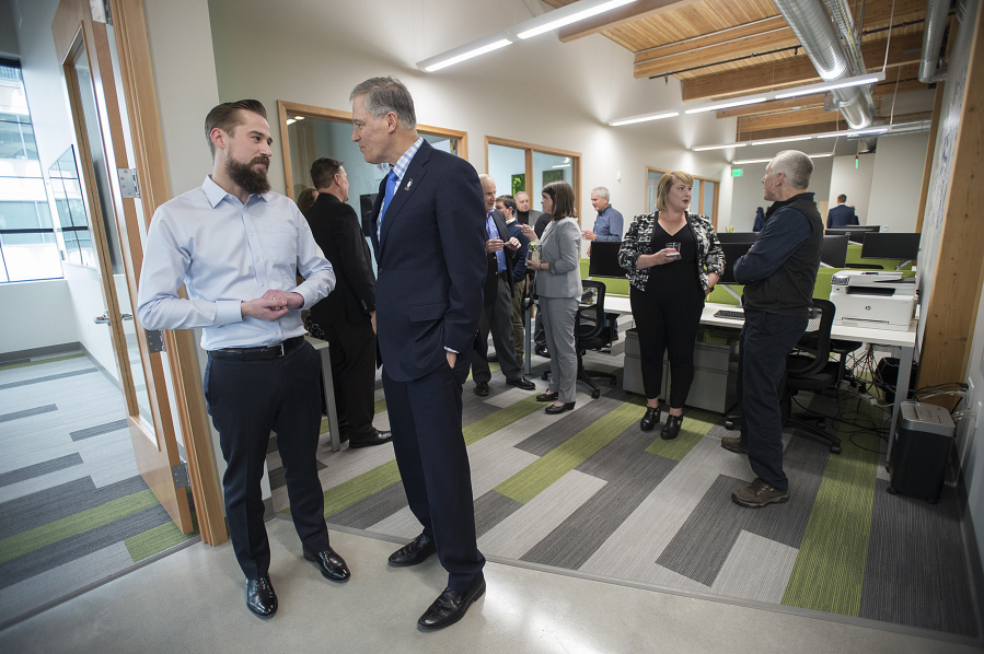 AbSci founder and CEO Sean McClain talks with Gov. Jay Inslee at an open house at AbSci offices in downtown Vancouver on Tuesday afternoon.