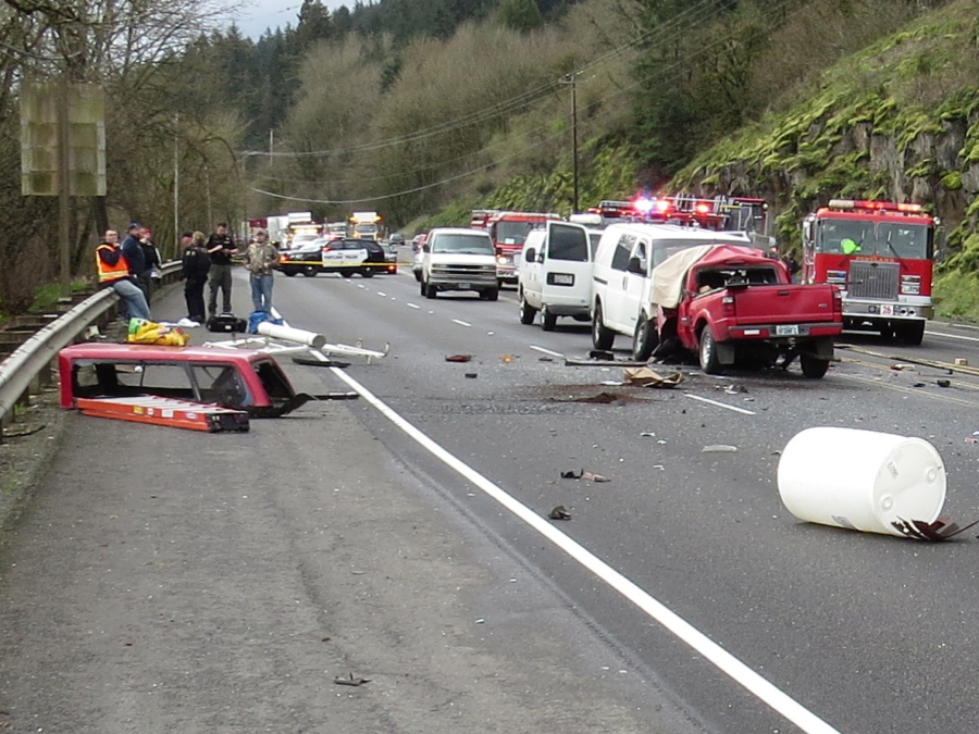 Law enforcement officials and ambulance crews respond Wednesday to the aftermath of a fatal, five-vehicle crash on Highway 30 in Oregon, near the Sauvie Island Bridge. One man was killed in the crash and three people, including two from Clark County, were hospitalized.