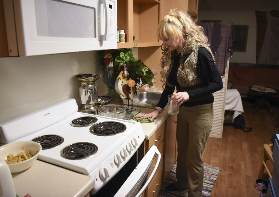 Ronda McDeavitt, 49, cleans the kitchen in her micro-studio apartment at Lincoln Place. &quot;I&#039;m a lot more grateful for this place. I&#039;m grateful that I wasn&#039;t able to just leave and that I didn&#039;t leave because I got a lot of growth from it,&quot; she said.