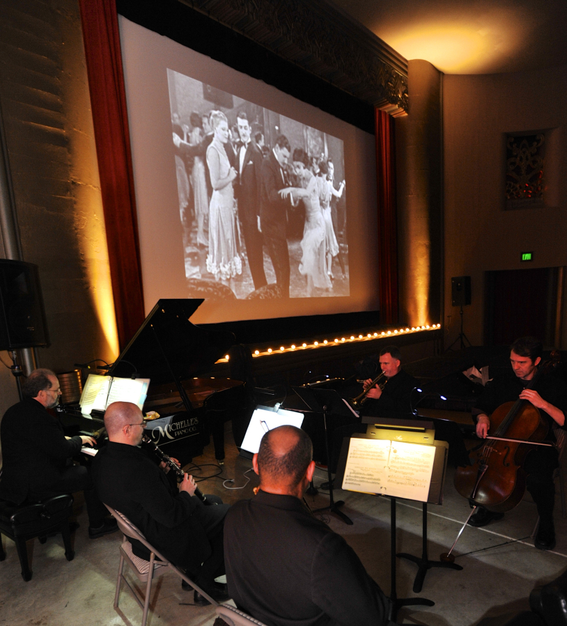A small group of musicians from the Vancouver Symphony Orchestra, with Rodney Sauer on piano, accompany a silent comedy at the Kiggins Theatre in 2016.