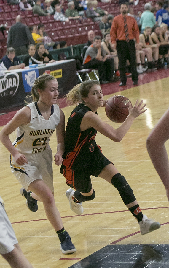 Washougal guard Mason Oberg (4), drives to the hoop before being blocked during the second round of the WIAA 2A girls state tournament on Thursday, Mar. 2, 2017, at the Yakima Valley SunDome. The Burlington-Edison Tigers defeated the Washougal Panthers 58-55.