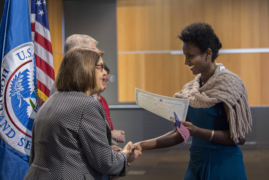Vancouver Community Library manager Jackie Spurlock, left, congratulates new American citizen Fiyori Hagos, a Portland resident from Ethiopia, after the swearing-in ceremony Friday morning at the library.