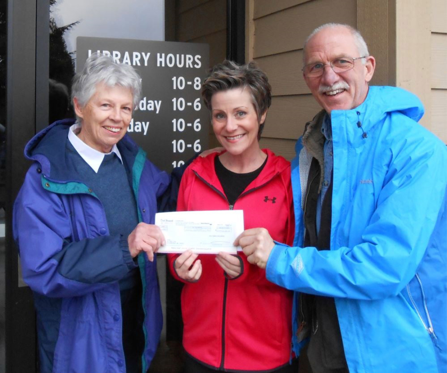 Ridgefield: Rhonda Pfeifer, Dick Hannah Dealerships vice president assistant, center, presents Kathy Winters, left, and Tevis Laspa with a $13,000 check for the Ridgefield Community Library building fund.
