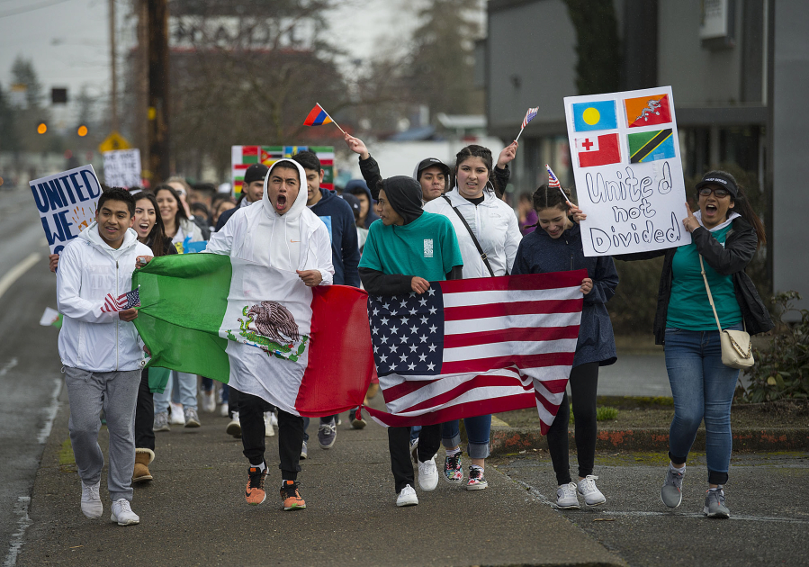 Vancouver students show their support for minority and immigrant students as they march along East Fourth Plain Boulevard on Monday afternoon. In an organized walkout, more than 100 students left class to protest the Trump administration&#039;s policies on immigration and to call on Vancouver Public Schools to issue a letter saying students are safe on campus.