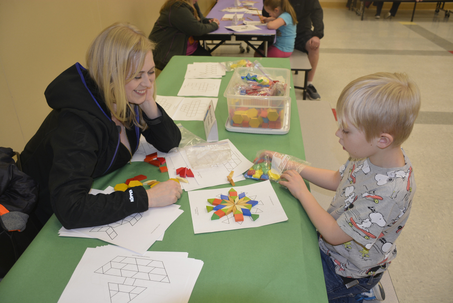 Washougal: Kayla and Tanner Woods at Hathaway Elementary School&#039;s Family Math Night, where students and their families solved puzzles, built clocks and competed in multiplication contests.
