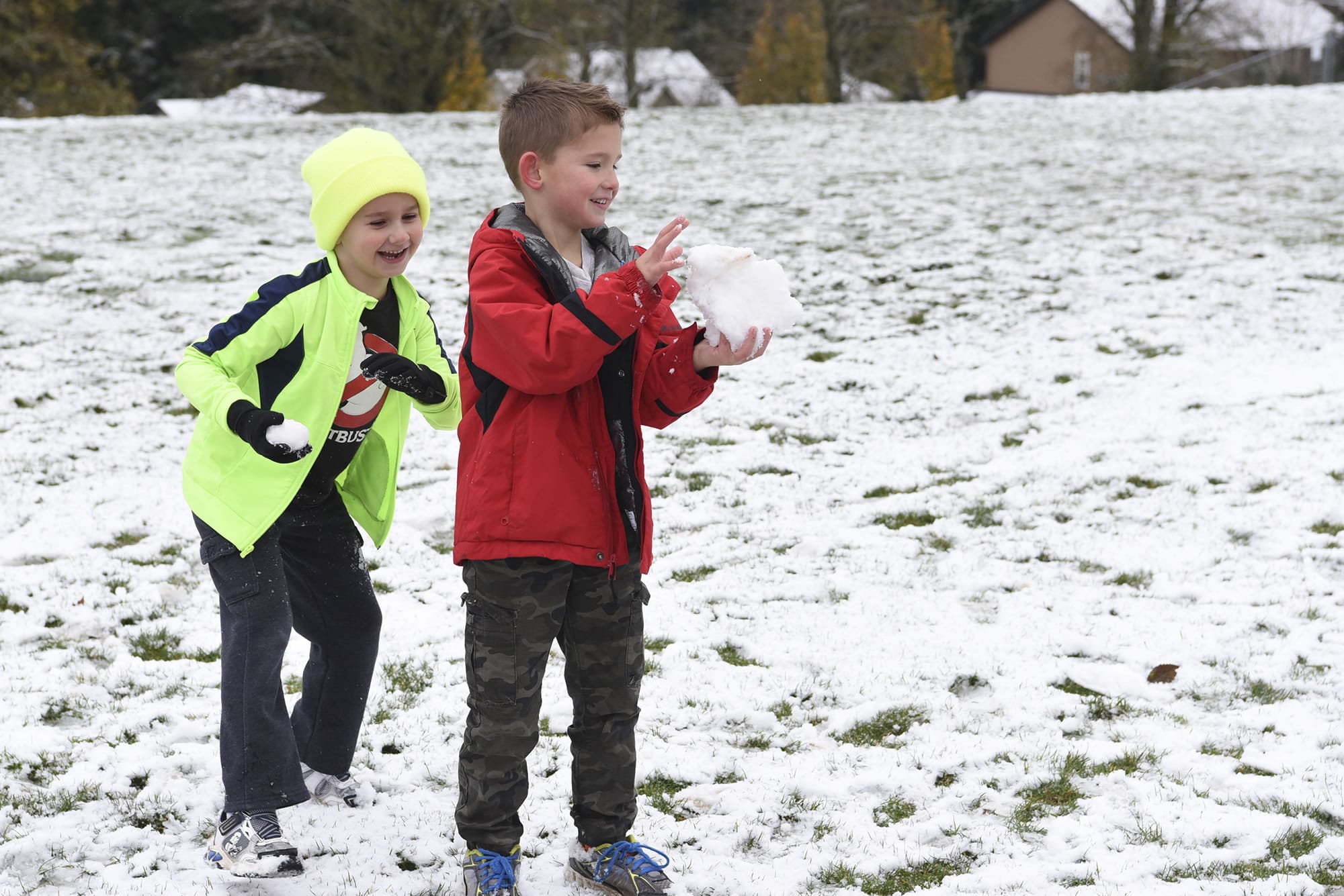 Kindergartener Evan Salmon, center, prepares a giant snowball while Daniel Blaser sneaks up behind him with a snowball during recess at Prune Hill Elementary School on Dec. 5. There was school that day, but the Camas School District canceled 10 days of school this school year due to snow and inclement weather. The district received a waiver for four of those days.