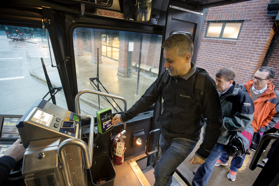 Vancouver resident and electronic fare beta tester Nate Silva swipes his Hop Fastpass as he boards the bus at the Fisher&#039;s Landing Transit Center Monday morning. Silva was one of the first 250 people in the metro area selected to test the new payment system.