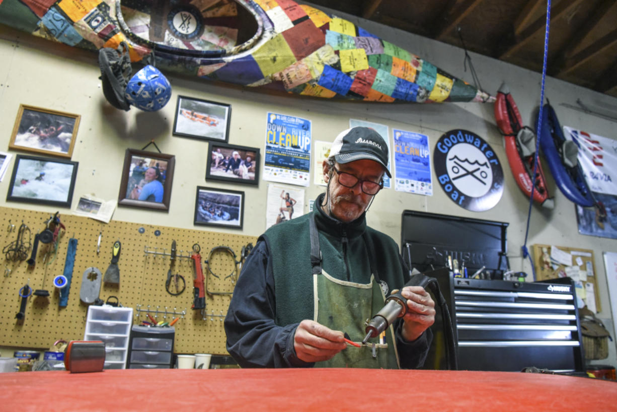 Vic LeGall, owner of Goodwater Boat Works in Vancouver, repairs a kayak in his shop.