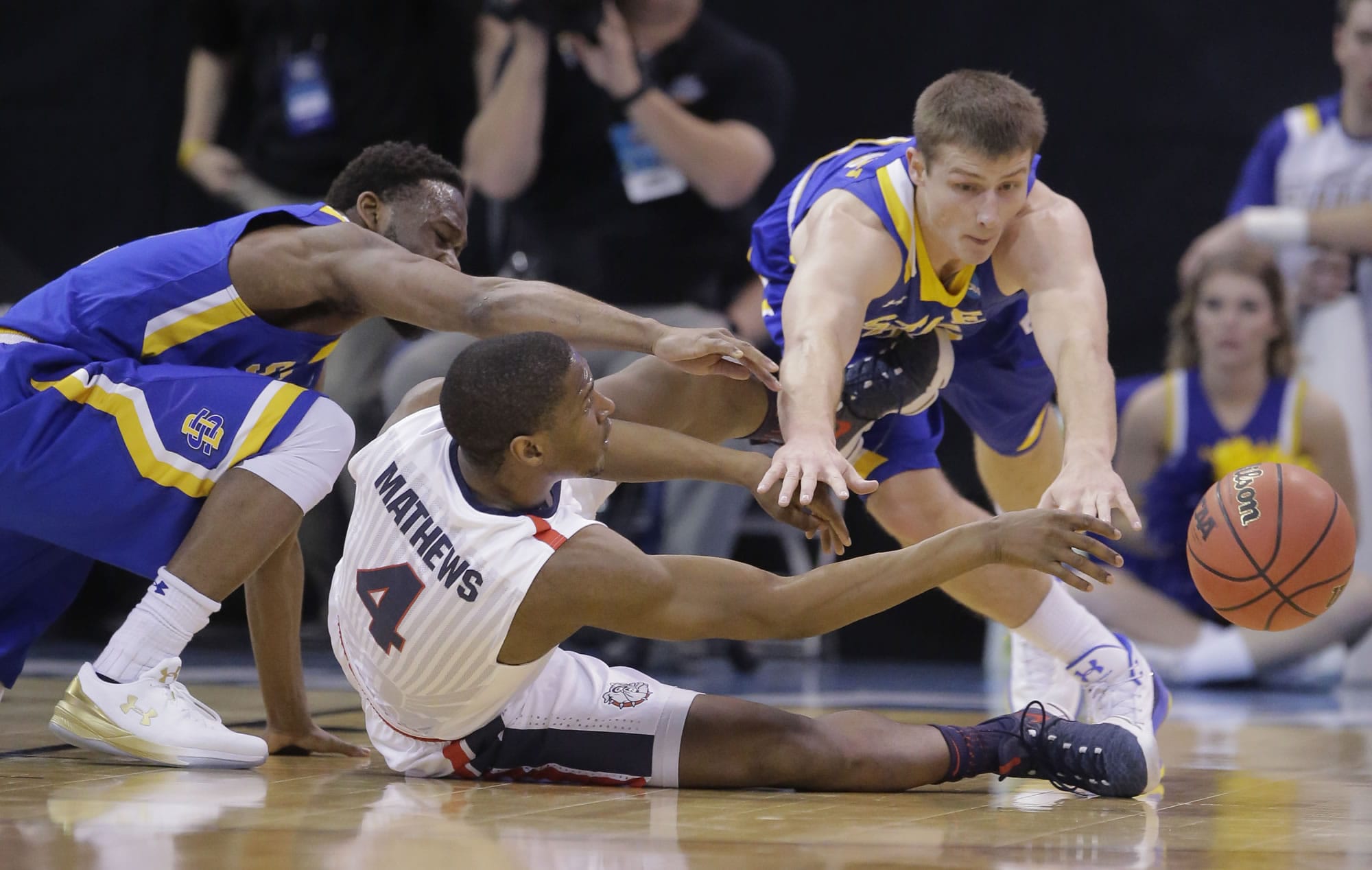 Gonzaga guard Jordan Mathews (4) passes the ball as South Dakota State's Tevin King, left, and Lane Severyn, right, defend during the first half of a first-round men's college basketball game in the NCAA Tournament, Thursday, March 16, 2017, in Salt Lake City.