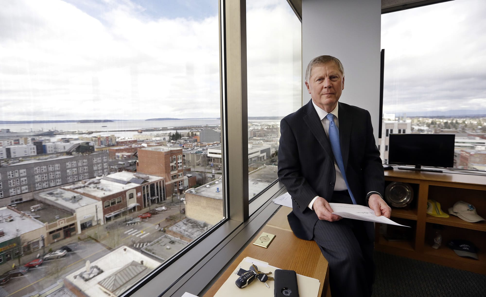 FILE--In this Feb. 16, 2017, file photo, Everett Mayor Ray Stephanson sits in his corner office overlooking downtown Everett, Wash. Stephanson is suing pharmaceutical giant Purdue Pharma, becoming the first city to try to hold the maker of OxyContin accountable for damages to his community. Connecticut-based Purdue Pharma argued in court documents filed Monday, March 20, 2017, there is no legal basis for such a lawsuit.