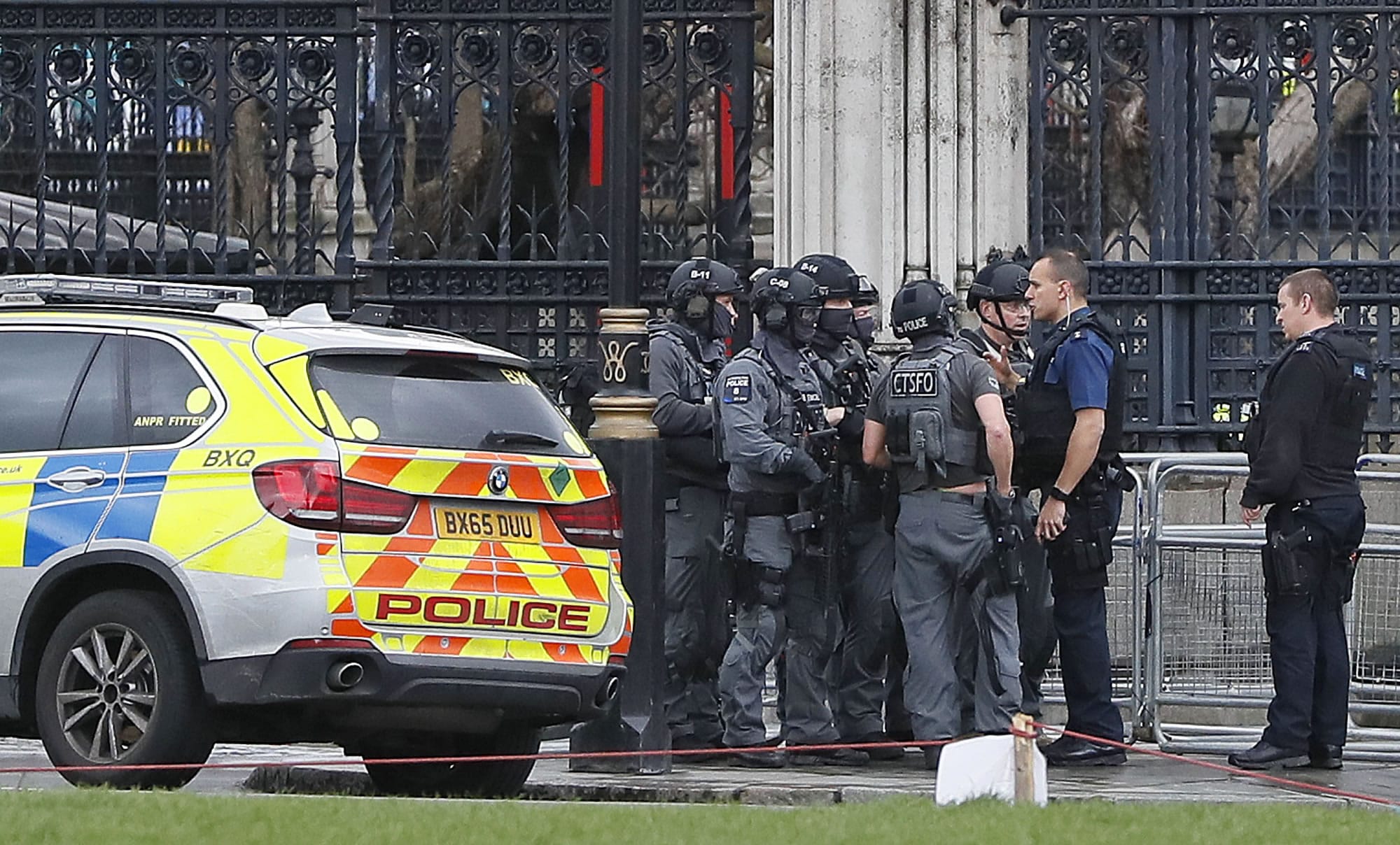 Armed police officers gather outside of the Houses of Parliament in London, Wednesday, March 23, 2017 after the House of Commons sitting was suspended as witnesses reported sounds like gunfire outside. The leader of Britain's House of Commons says a man has been shot by police at Parliament.