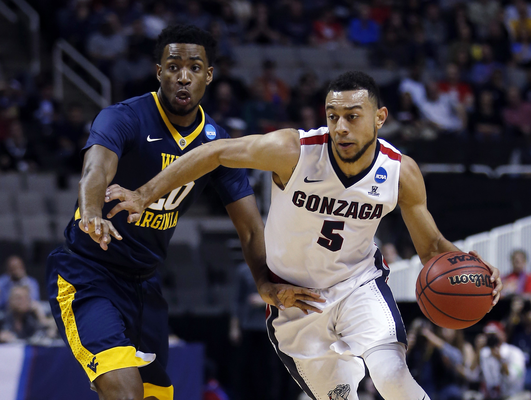 Gonzaga guard Nigel Williams-Goss (5) is defended by West Virginia forward Brandon Watkins during the first half of an NCAA Tournament college basketball regional semifinal game Thursday, March 23, 2017, in San Jose, Calif.