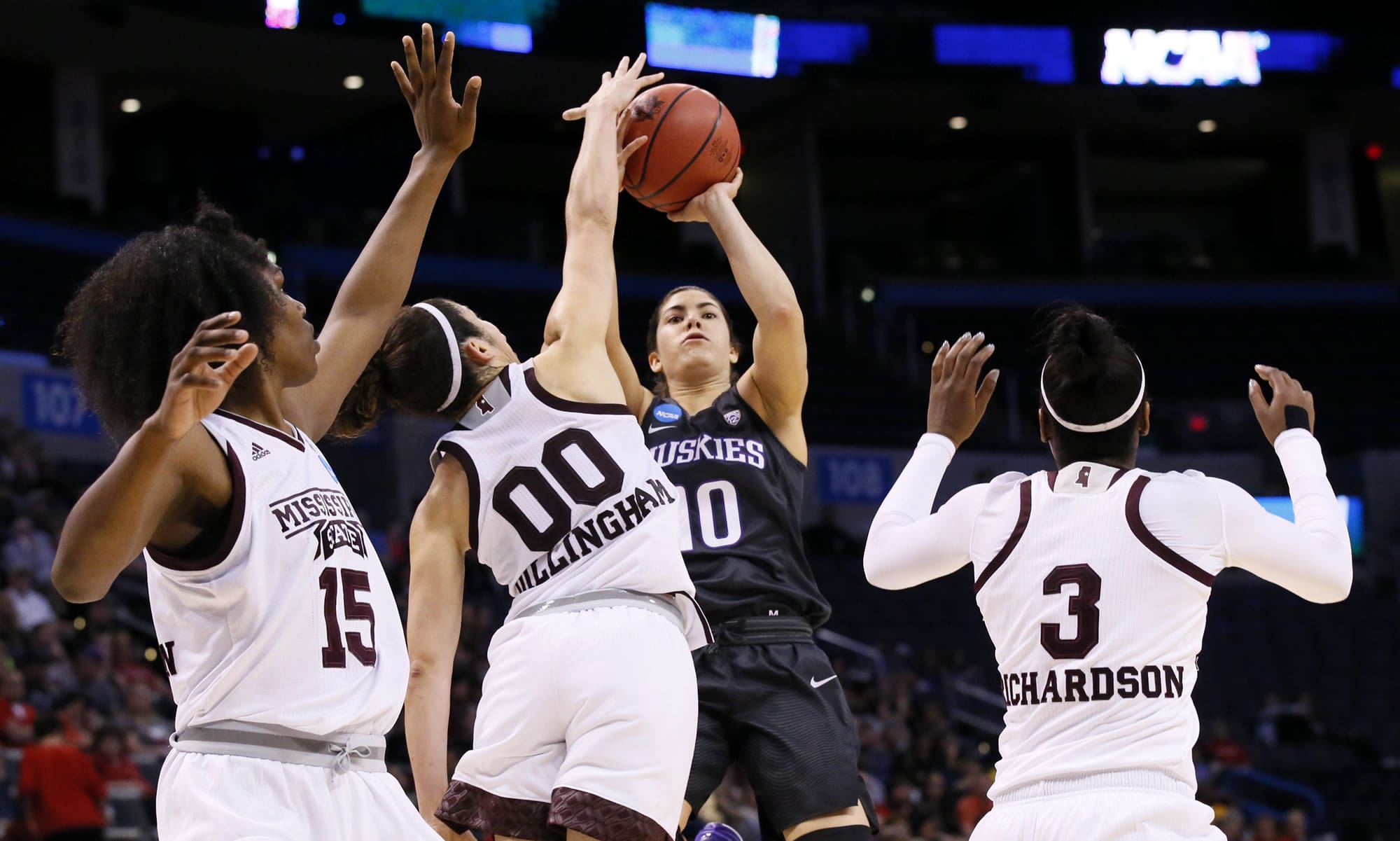 Washington guard Kelsey Plum (10) shoots over Mississippi State's Teaira McCowan (15), Dominique Dillingham (00) and Breanna Richardson (3) during the second half of a regional semifinal of the NCAA women's college basketball tournament, Friday, March 24, 2017, in Oklahoma City.