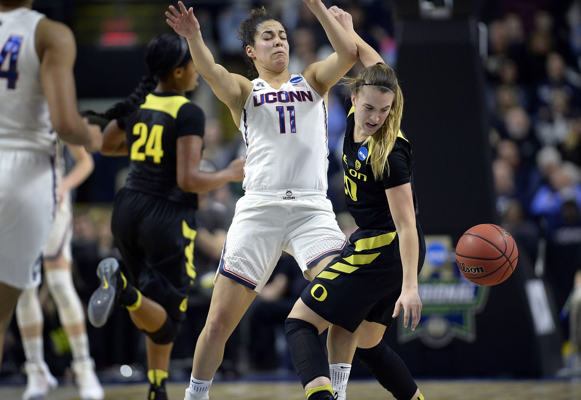 Oregon's Sabrina Ionescu, right, tries to gather the ball after running into the defense by Connecticut's Kia Nurse during the first half of a regional final game in the NCAA women's college basketball tournament, Monday, March 27, 2017, in Bridgeport, Conn.